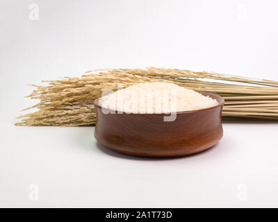 rice seed ,Placed in wooden bowl on a white background. Stock Photo