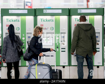 Gelsenkirchen, Germany. 27th Sep, 2019. Rail passengers buy their tickets at the new VRR ticket vending machines. From mid-December 2019, the railway will no longer sell VRR tickets at stations in the VRR region. The transport association has commissioned a new service provider to take over the sale. The ticket vending machines are no longer rail red, but VRR green. Credit: Roland Weihrauch/dpa/Alamy Live News Stock Photo