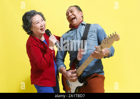 Sing happy old man playing the guitar Stock Photo