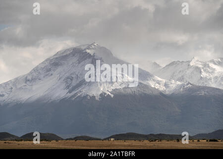 Snowy mountain peak in moody weather.  Puerto Natales, Provincia de Magallanes, Chile. Stock Photo