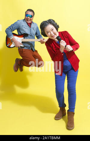 Sing happy old man playing the guitar Stock Photo