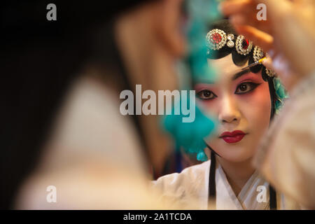 Female Peking Opera actor backstage makeup Stock Photo