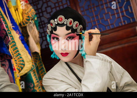 Female Peking Opera actor backstage makeup Stock Photo