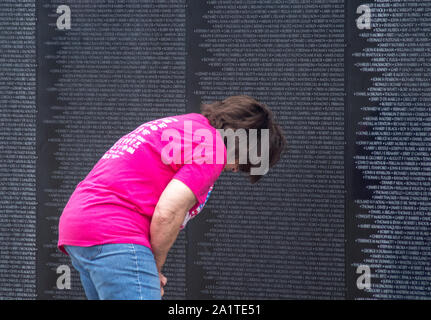 South Bend Indiana USA, September 21 2019; a woman looks for a name on the traveling Vietnam Memorial wall Stock Photo
