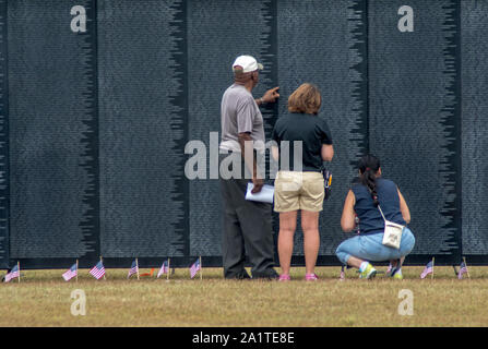 South Bend Indiana USA, September 21 2019; a group of people look for names on the traveling vietnam memorial wall Stock Photo