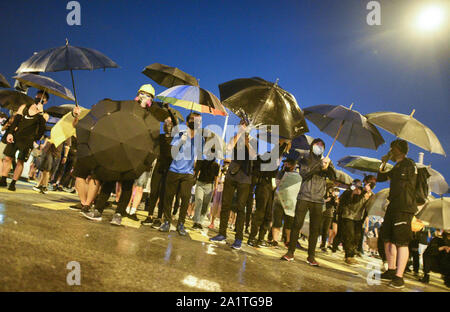 *** STRICTLY NO SALES TO FRENCH MEDIA OR PUBLISHERS *** September 28, 2019 - Hong Kong, China: Protesters clash against police, using their umbrellas to protect themselves from water thrown at them. Tens of thousands of people gathered in Tamar park to mark the five-year anniversary of the Umbrella movement. Stock Photo