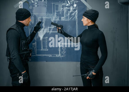 Two robbers working on a plan to rob the vault Stock Photo