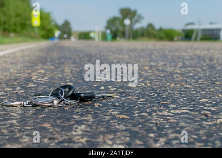 Lost a bunch of keys lying on the asphalt surface of the roadway Stock Photo