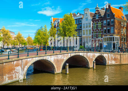 Picturesque travel and touristic location. Beautiful water canals and waterways with spectacular traditonal dutch buildings, Amsterdam, Netherlands, E Stock Photo