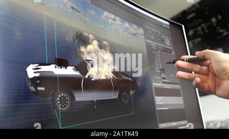 game design software of hand with pen explain how to design car model for videogame on screen Stock Photo