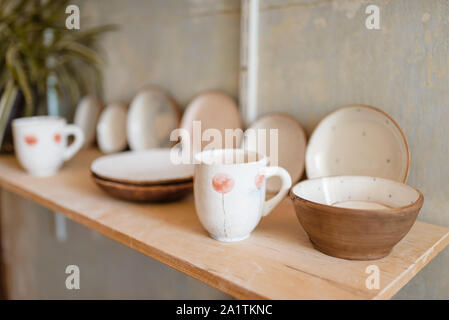 Kitchen utensils on shelf in pottery workshop Stock Photo