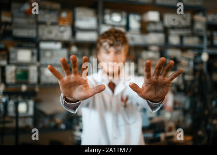 Strange scientist showing scorched hands in lab Stock Photo