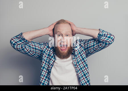 Attractive handsome good-looking person man in casual checkered shirt open mouth staring eyes hold hand on head isolated on light gray background Stock Photo