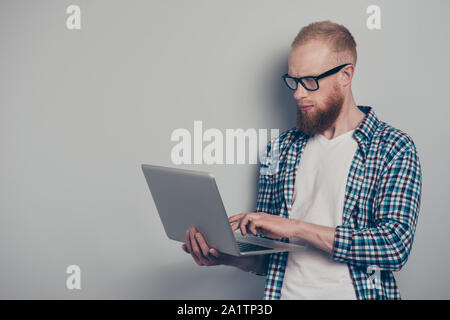 Photo portrait of attractive nice-looking good-wearing handsome man stand isolated on light gray background using notebook look at monitor screen Stock Photo