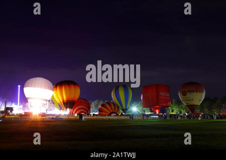 Hot Air Balloons lit up at night for the Night Glow event of York Balloon Fiesta at Knavesmire Racecourse in York,North Yorkshire UK. Stock Photo