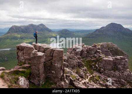 Hill walker on the summit of Stac Pollaidh, Assynt, NW Scotland Stock Photo