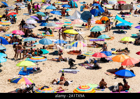Mallorca, Spain, August 16, 2019: view from above of beach crowded with tourists and colored umbrellas Stock Photo