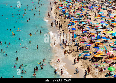 Mallorca, Spain, August 16, 2019: view from the top, of the beach and shoreline crowded with tourists and umbrellas Stock Photo