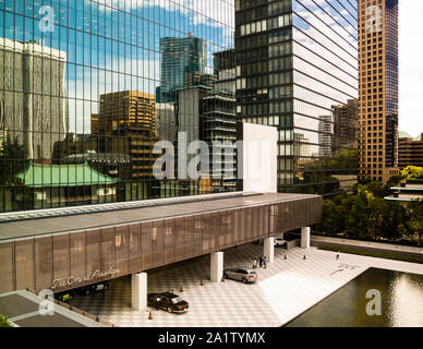 Tokyo skyline in the mirror of the Okura Hotel, Tokyo, Japan. The entrance area of the Okura Prestige in Tokyo. The checkerboard pattern of the driveway is also found in the lobby Stock Photo