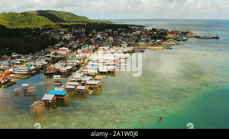 Village of stilt houses built over the sea, top view. Dapa, Siargao, Philippines. Stock Photo