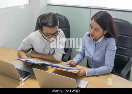Business employee reading information on sales report Stock Photo