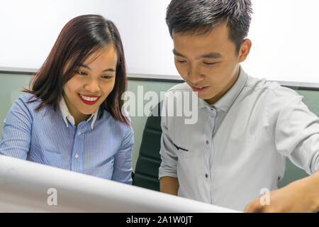 Asian business employees discuss about work on paper Stock Photo