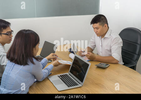 Business people having discussion with laptop and document at office Stock Photo