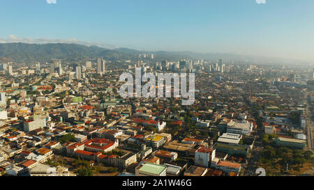 Aerial view of panorama of the city of Cebu with skyscrapers and buildings during sunrise. Philippines. Stock Photo