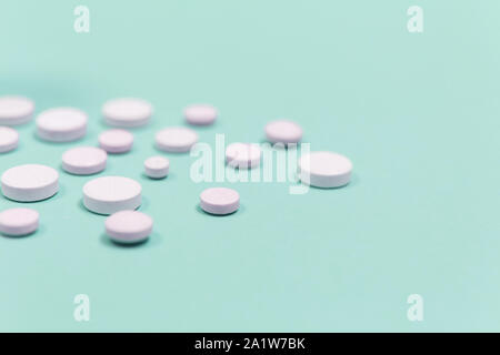 White pill on a purple background with copy space. Antibiotics drug resistance. Antimicrobial capsule pills. Pharmaceutical industry. Pharmacy. Stock Photo