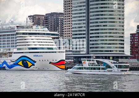 Rotterdam, The Netherlands, September 19, 2019: Cruise ship Aida Perla and Spido tour boat Marco Polo seemingly about to kiss in front of the World Po Stock Photo