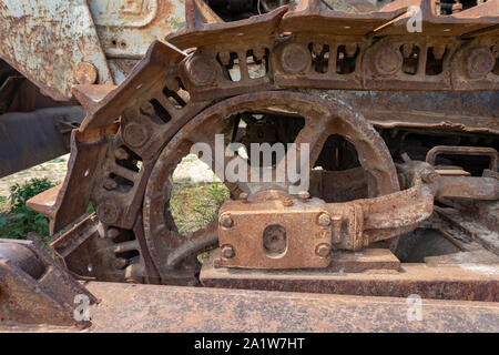 A close up of rusty steel tracks and parts on an old piece of machinery. Stock Photo
