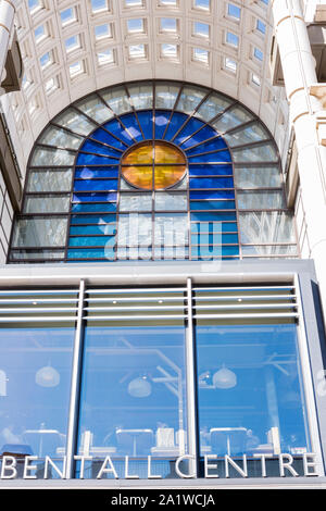 Modern glass arch and stained glass coloured windows at entrance of Bentall shopping centre, Kingston, London, UK,  cafeteria one floor below. Stock Photo