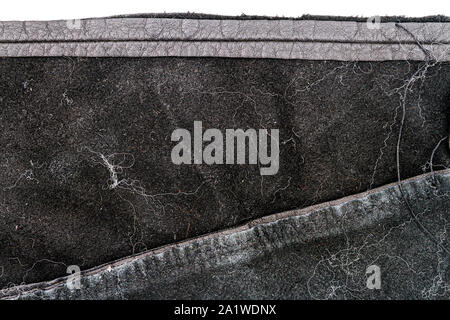 Piece of nessy black leather isolated on white background. Crumpled material texture. Back side Stock Photo