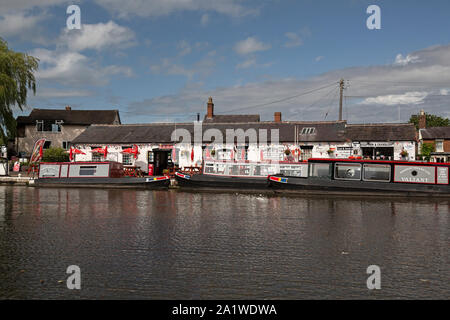Narrow Boats, or Barges, moored up at Norbury Wharf on The Shropshire Union Canal in England. Stock Photo