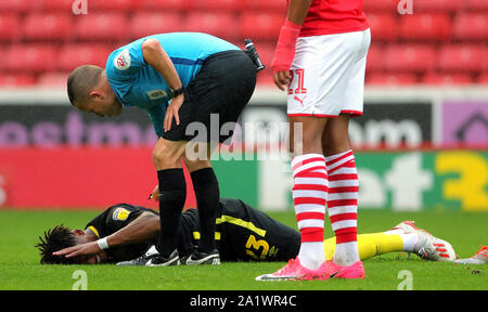 Brentford's Julian Jeanvier (left) on the ground after picking up an injury during the Sky Bet Championship match at Oakwell, Barnsley. Stock Photo