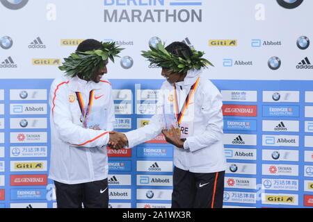 09/19/2019, Berlin, Germany,  Kenenisa Bekele and  Ashete Bekere at the awards ceremony. Kenenisa Bekele from Ethiopia wins the 46th Berlin Marathon in 02:01:41 hours. Birhanu Legese (2:02:48) wins the second place and Sisay Lemma (2:03:36) comes in third place. Stock Photo