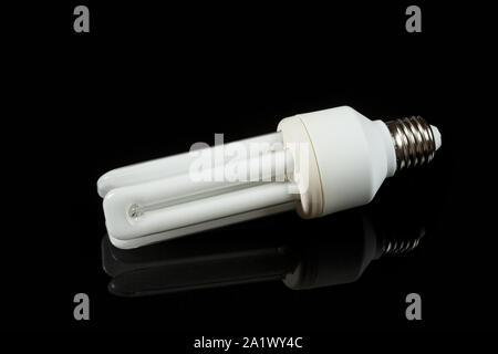 fluorescent energy saving lamps on black isolated background. on the glass Stock Photo