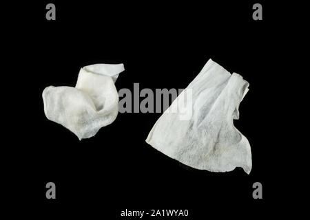 a crumpled paper napkin on a black insulated background. on the glass Stock Photo