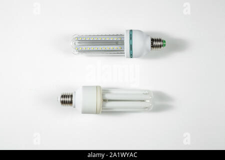 led and fluorescent energy saving lamps on white isolated background. on the glass Stock Photo