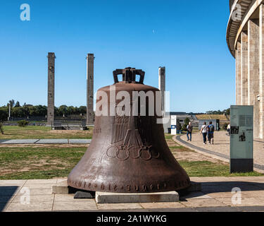 Berlin, Olympic Stadium grounds. Tall Towers & damaged Olympic Bell from the Bell Tower is inscribed with Olympic Rings, an eagle, the year 1936 Stock Photo