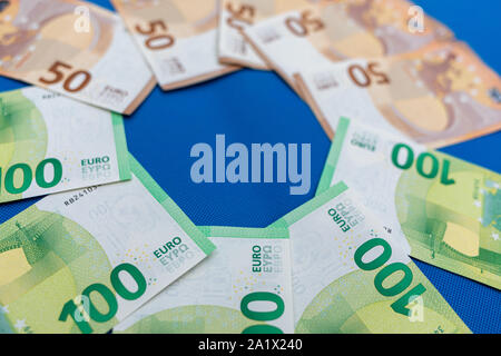 a lot of euro banknotes lie spread out on a blue base Stock Photo