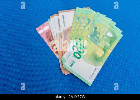 a lot of euro banknotes lie spread out on a blue base Stock Photo