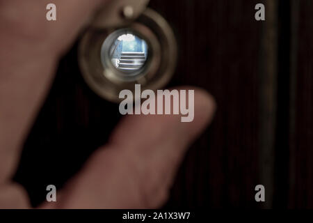 View through the peephole on the landing. Sharpness on the stair step. Stock Photo