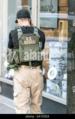 NYC, 9/27/2019: US marshal is talking on the phone while
