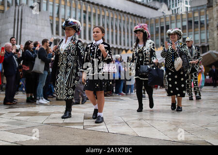 The Pearly Kings and Queens gather at the Guildhall Square as they parade to St Mary-le-Bow church to celebrate the harvest festival. Stock Photo