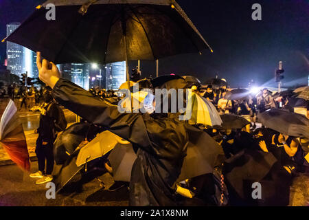 Hong Kong, China. 28th Sep, 2019. A protester taunts riot police from across the barricade during the demonstration.During the 17th weekend of consecutive demonstrations, protesters attend a rally marking the 5th year anniversary of the Umbrella Revolution. They chanted slogans and continued to ask for the five demands to be met. Later in the night, protesters clashed with riot police and eventually fled after being sprayed by water cannons. Credit: Willie Siau/SOPA Images/ZUMA Wire/Alamy Live News Stock Photo