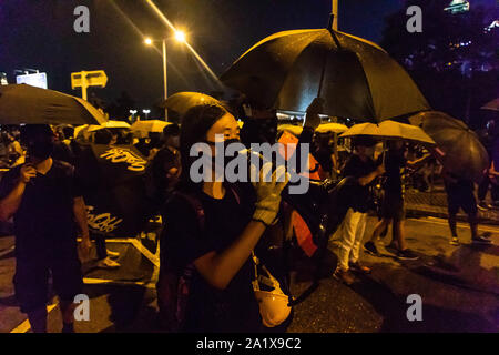 Hong Kong, China. 28th Sep, 2019. A protester taunts riot police using a megaphone during the demonstration.During the 17th weekend of consecutive demonstrations, protesters attend a rally marking the 5th year anniversary of the Umbrella Revolution. They chanted slogans and continued to ask for the five demands to be met. Later in the night, protesters clashed with riot police and eventually fled after being sprayed by water cannons. Credit: Willie Siau/SOPA Images/ZUMA Wire/Alamy Live News Stock Photo