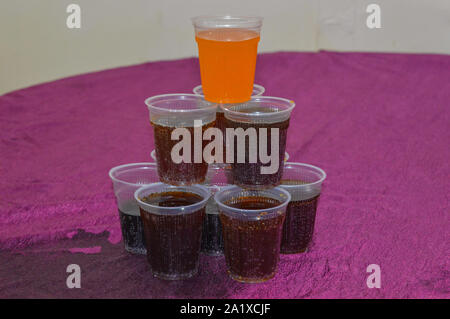 Pyramid of red paper cups on green background. minimalism concept Stock  Photo - Alamy