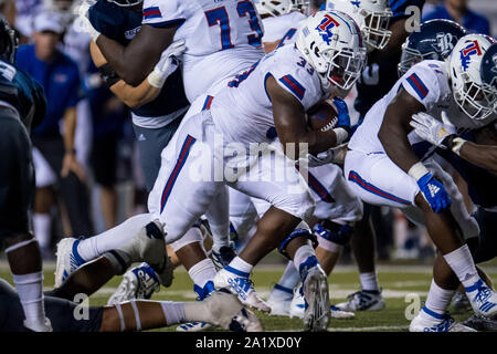 Overtime. 28th Sep, 2019. Louisiana Tech Bulldogs running back Justin Henderson (33) carries the ball during the overtime period of an NCAA football game between the Louisiana Tech Bulldogs and the Rice Owls at Rice Stadium in Houston, TX. Louisiana Tech won the game 23 to 20 in overtime.Trask Smith/CSM/Alamy Live News Stock Photo