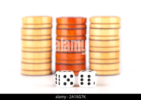 Selective focus. Backgammon dice and wooden checkers isolated on a white background. Copy space. Board games concept. Stock Photo